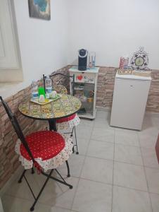 une cuisine avec une table, deux chaises et une table dans l'établissement I colori di Iglesias, à Iglesias