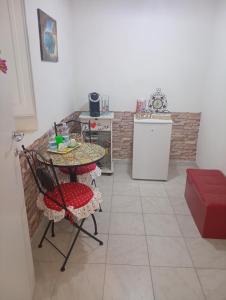 a small kitchen with a table and a table and a chair at I colori di Iglesias in Iglesias