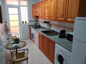 a kitchen with a sink and a dishwasher at CONFORTABLE, BRIGHT, WELL LOCATED APARTMENT in Morro del Jable