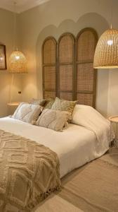 a bedroom with a large white bed with two lamps at T2 Apartment Old Village Vilamoura in Vilamoura