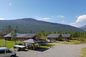 a group of buildings with a mountain in the background at Visit Junkerdal in Junkerdal