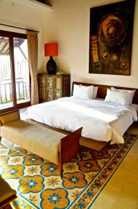 A bed or beds in a room at Aqua Octaviana Bali Villa