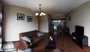 a living room with a couch and a table at Apartament Orlowo in Gdynia