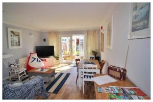 a living room with a couch and a table at Self Contained Flat with Private Garden & Parking in Sandown