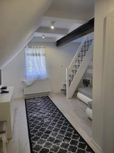 a living room with a staircase and a rug at Gold Hill in Miłków