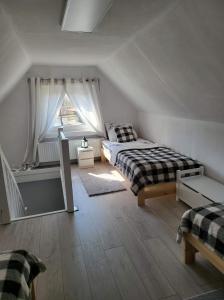 a bedroom with a bed and a window at Gold Hill Karpacz -Miłków in Miłków
