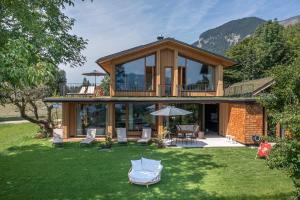 a house with a large deck on a lawn at Balthasar Volcano Apartments - Adults only in St. Wolfgang