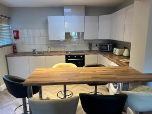 a kitchen with a wooden table and chairs at Kinsale town cosy home 2 min walk to town center in Kinsale