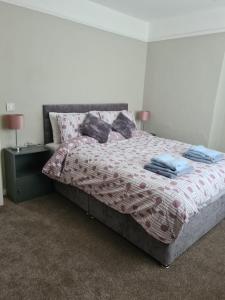 a bedroom with a bed with towels on it at Kinsale town cosy home 2 min walk to town center in Kinsale