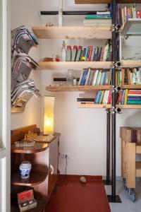 a room with shelves filled with books at Downtown Apartment in Pescara