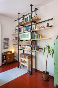 a book shelf filled with books in a room at Downtown Apartment in Pescara