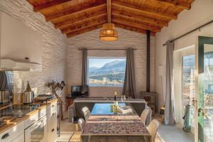 a kitchen with a table and a large window at Quinta do Monte Travesso - Country Houses & Winery in Tabuaço