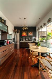 a kitchen with a table and a dining room at Ana Frank Boutique Hotel in Lima