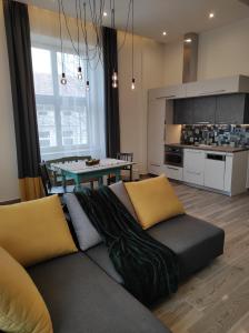 a living room with a couch and a table at City Art Inn in Szeged