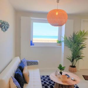 a living room with a view of the ocean at The Shore @ Atlantic Beach - Waterfront Beach House, Tiny Pool, Terrasse in Espinho