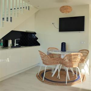 a dining room with a table and chairs at The Shore @ Atlantic Beach - Waterfront Beach House, Tiny Pool, Terrasse in Espinho