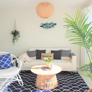 a living room with a couch and a table at The Shore @ Atlantic Beach - Waterfront Beach House, Tiny Pool, Terrasse in Espinho