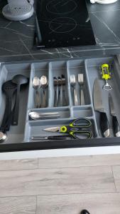 a drawer filled with utensils in a kitchen at Cenkones Street Apartment in Liepāja