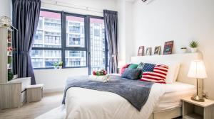 a bedroom with a bed with patriotic pillows at The Arte Plus KLCC BY Tenang Homes in Kuala Lumpur
