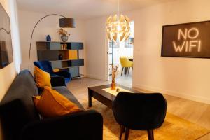 a living room with a couch and a table at Casa Aire de Mar, modern house with private pool, overlooking Baviera golf, within walking distance of beach in Vélez-Málaga