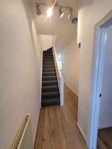 a hallway with a staircase in a building at Courtybella Mews in Newport