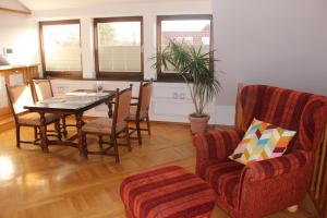 a living room with a dining room table and chairs at Weite Blicke in Horn-Bad Meinberg