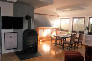 a living room with a wood stove and a table at Weite Blicke in Horn-Bad Meinberg
