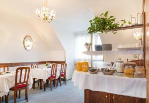 a dining room with two tables with white table cloth at Pension Dr. Geissler in Vienna