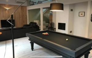 a living room with a pool table in it at Le jacuzzi de Marie ll in Tourcoing