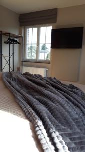 a large blanket on a bed in a bedroom at B&B Valant in Bruges