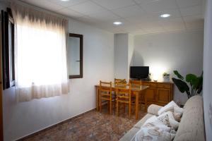 a living room with a couch and a table and a television at Casa Ramos in Navarrés
