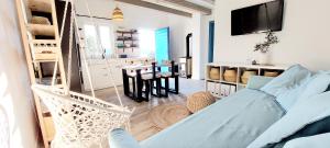 a living room with a hammock and a dining room at Seaside cottage 'Little white port' in Lučica