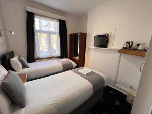 Postel nebo postele na pokoji v ubytování Apollo Hotel Kings Cross