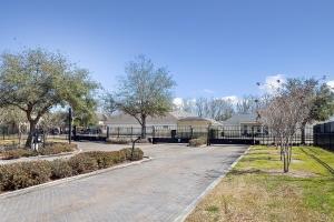 a road in a park with trees and a fence at ALL NEW - Designer Luxury 3BR Townhouse - Near LSU in Baton Rouge