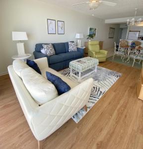a living room with a white couch and a table at Shoalwater 604 Condo in Orange Beach