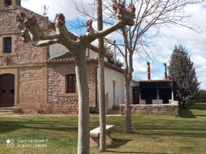 a house with two trees in front of it at La casita de mi abuela in Santo Domingo de la Calzada