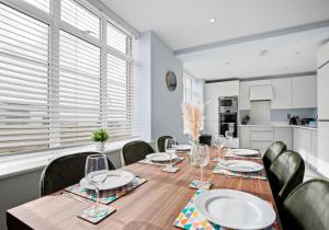 a dining room with a wooden table and chairs at Southern View By My Getaways in Brighton & Hove