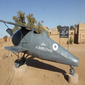 a military plane on display in a desert at Hotel Riad Le Petit Prince in Merzouga