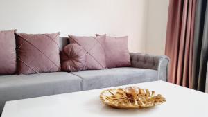 a bowl on a table in front of a couch at Skyline apartment in Bijeljina