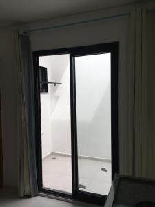 a sliding glass door in a room with a bathroom at H34 Hotel in Guarulhos +46 photos
