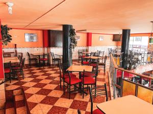 a restaurant with tables and chairs and a checkered floor at Hotel Cordillera Blanca in Caraz +192 photos