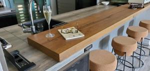 a bar with a glass of champagne and stools at Villa Celeste in Rena Majore