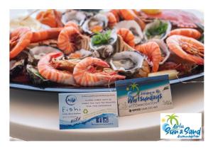 a plate of seafood with a plate of shrimp and seafoods at Airlie Sun & Sand Accommodation #3 in Airlie Beach +20 photos