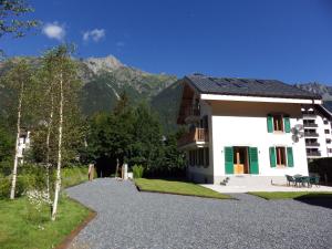 a small white building with a mountain in the background at Chalet Oryx in Chamonix