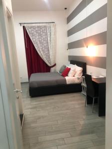 1 dormitorio con cama, mesa y escritorio en Napoli DownTown, en Nápoles