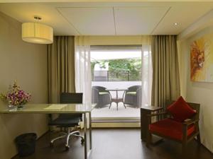 an office with a desk and chairs and a table at Hotel Grande 51 in Navi Mumbai