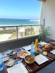 a table with food and a view of the ocean at sea view in ‘Akko