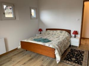 a bedroom with a bed and two lamps and two windows at New Spacious Appart. Incredible view of Mt Blanc in Passy