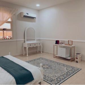 a white bedroom with a bed and a sink at Hideout Farmhouse - By Seven Elements in Ras al Khaimah