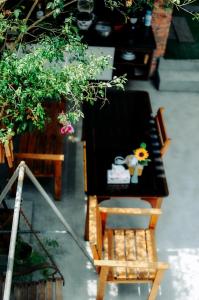 a table and a chair in a room with plants at Chi Homestay #3 in Hue +24 photos